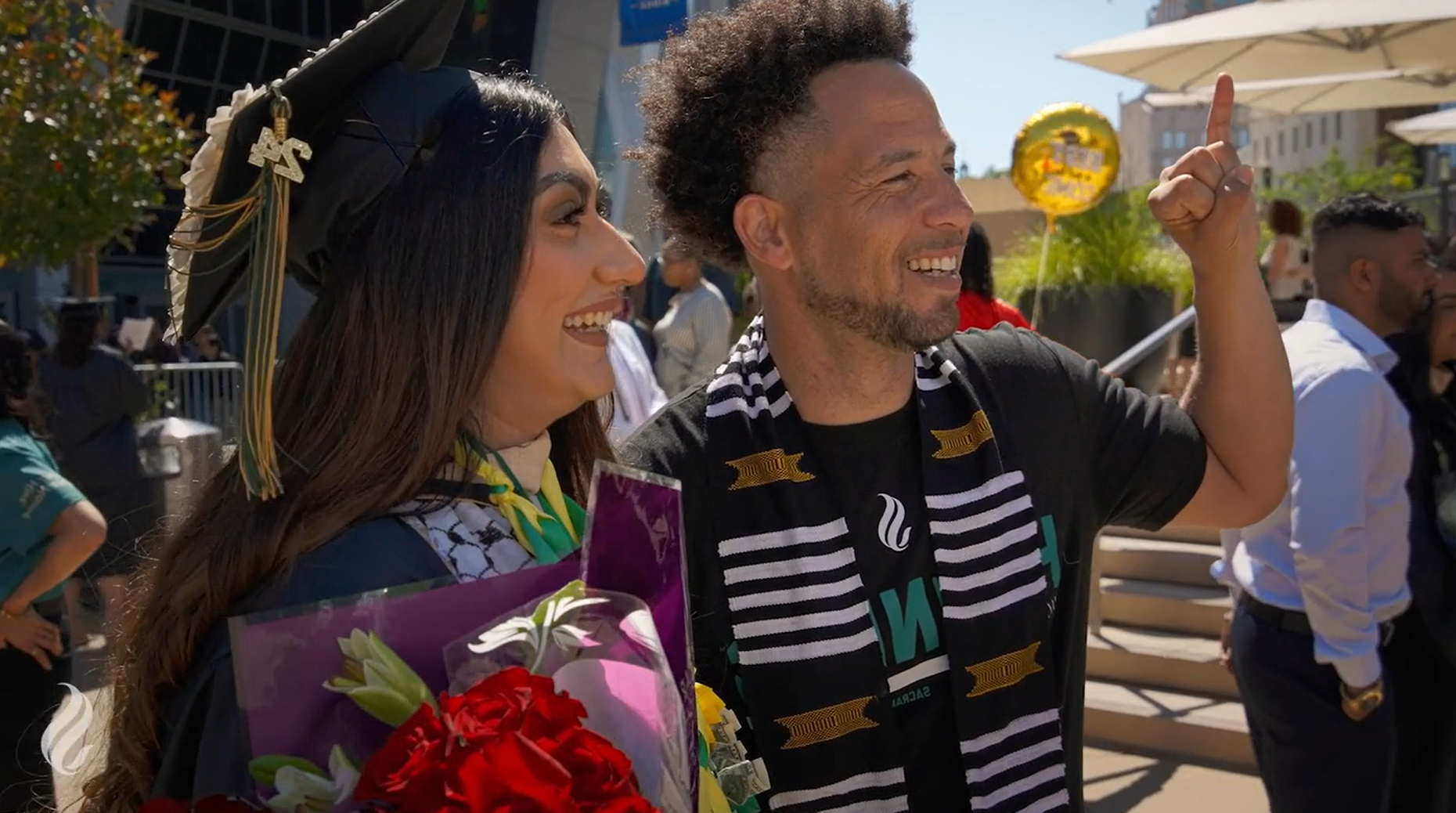 An image of President Wood and a graduate outside Golden 1 Center during the 2024 Commencement ceremonies. 