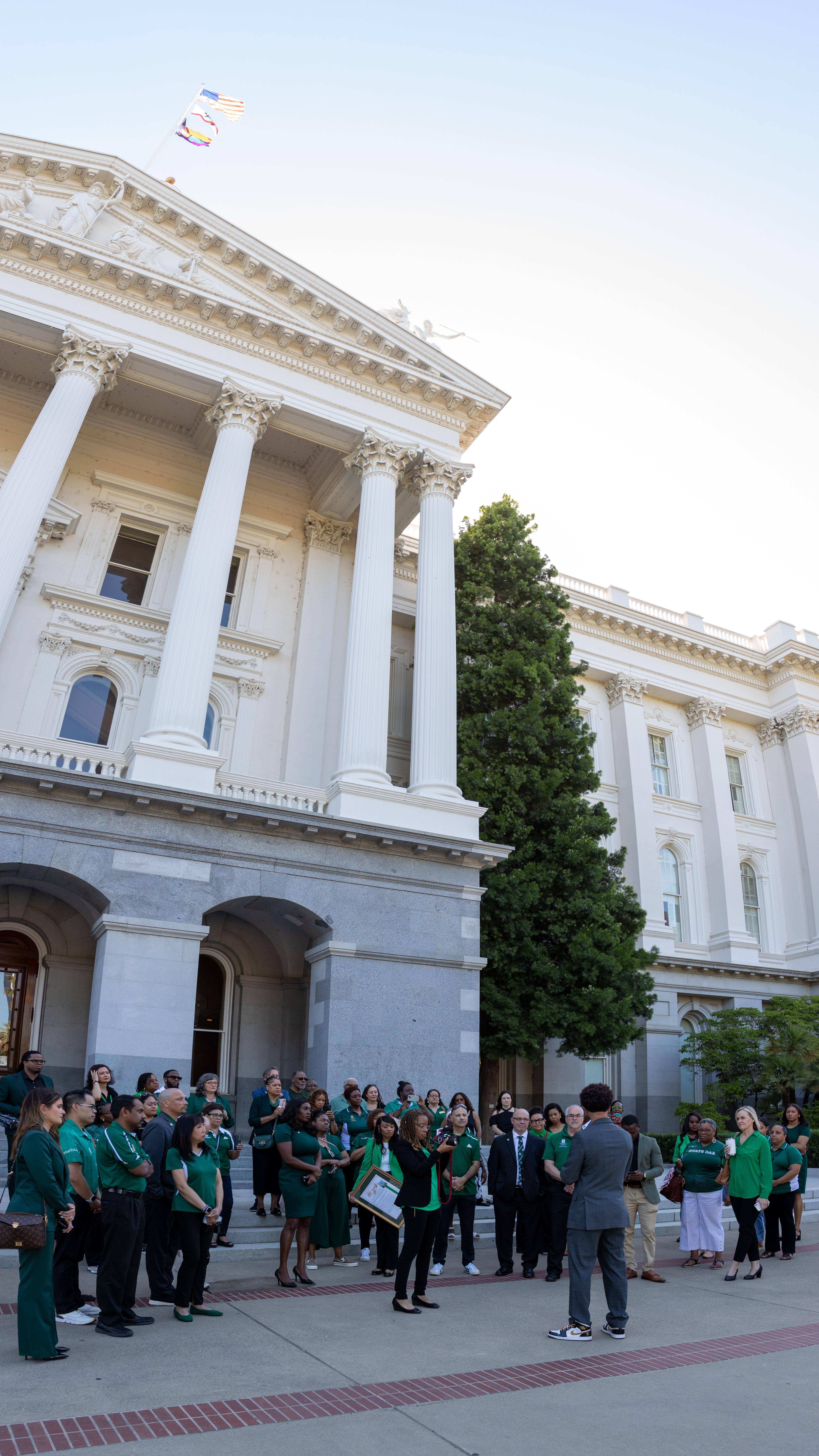 Members of campus community meet outside state Capitol. 